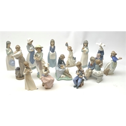 A group of thirteen Nao figurines, together with one Lladro figurine, each with printed mark beneath. 
