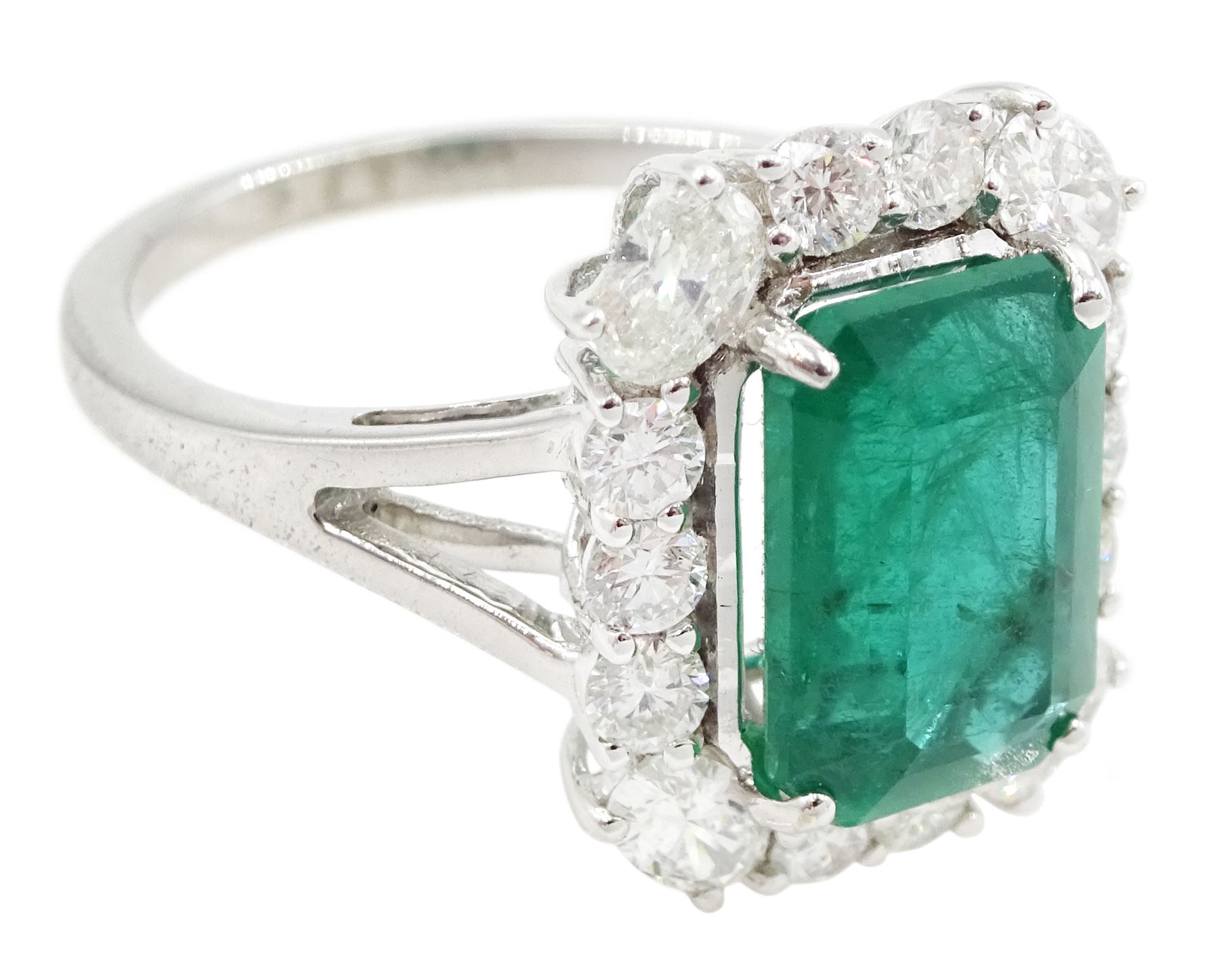 18ct white gold emerald and diamond cluster ring, single octagonal cut emerald of approx 2.90 carat, with oval cut diamonds set at each corner and round brilliant cut diamond surround, stamped, total diamond weight approx 0.90 carat