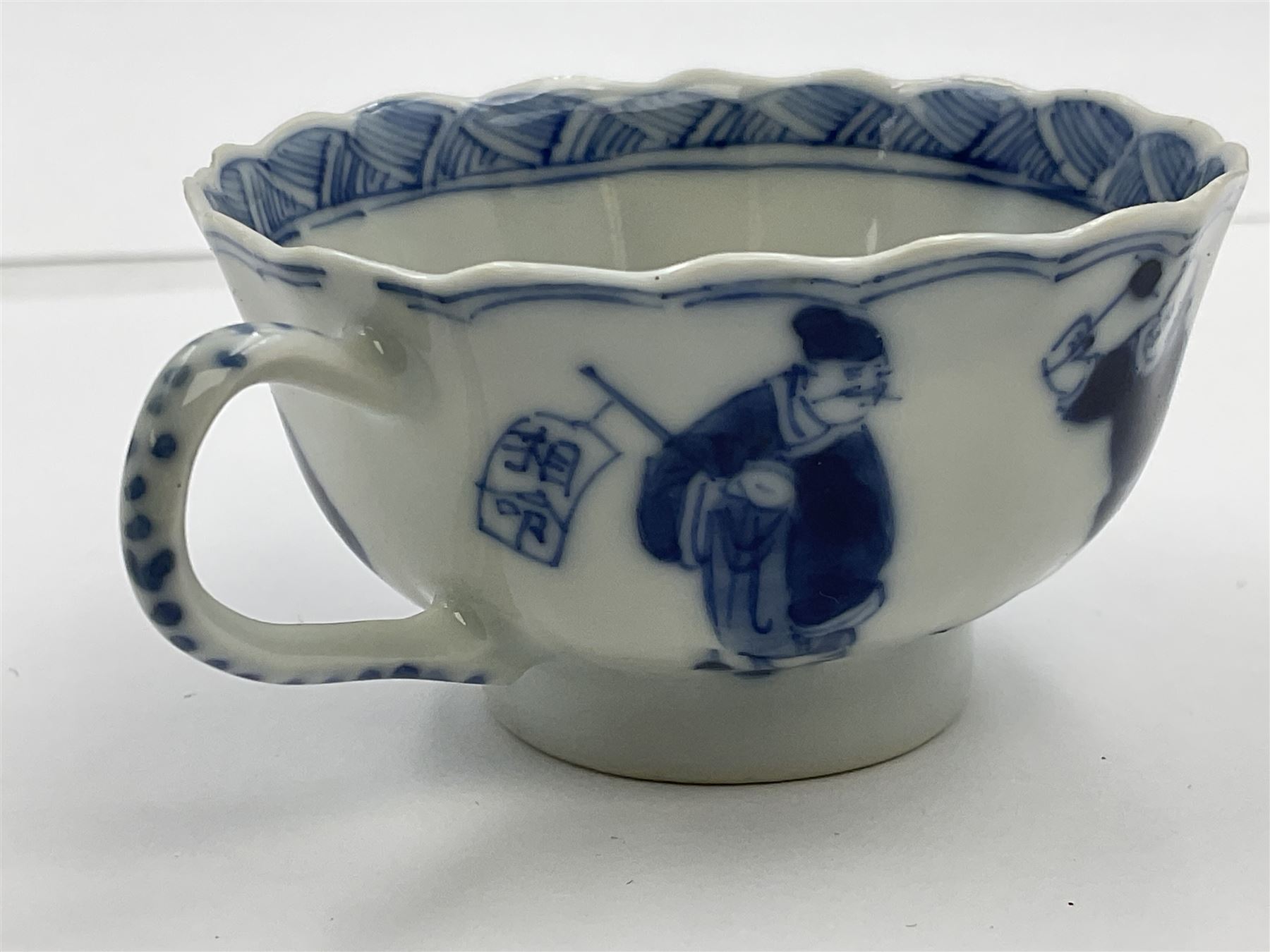 18th century Chinese blue and white Kangxi teacup and saucer, decorated with dancing figures, four character Kangxi mark beneath, saucer D10cm