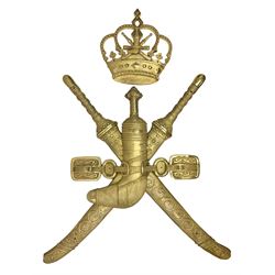 Gilt state emblem for Oman, a sheathed khanjar dagger superimposed above pair of crossed swords and belt and a seperate crown, main emblem H84cm, W83cm, crown H35cm, W33cm
Provenance by vendor repute: The emblem was previous mounted above HM's throne, in the main majalis, of the HM Royal Yacht AL Said, until 1985 when HM Sultan Qaboos ordered the upgrading of all state emblems, The emblem was gifted to the vendor who worked for the Sultans Royal Yacht Squadron