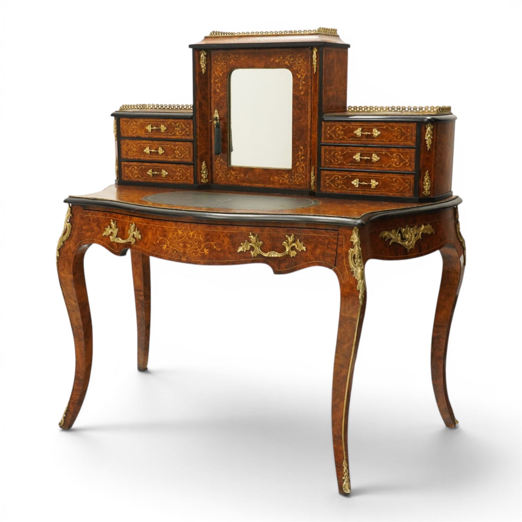 19th century French inlaid figured walnut and ebonised Bonheur de Jour or writing desk, the raised upper section with pierced brass three-quarter gallery, over a mirror glazed cupboard and a combination of drawers, the shaped and moulded top with leather inset and satinwood stringing, with brass beading too the ebonised edge, fitted with a serpentine fronted frieze drawer, raised on cabriole supports, inlaid throughout with scrolling foliate decoration in boxwood and ornate cast brass mounts and handles