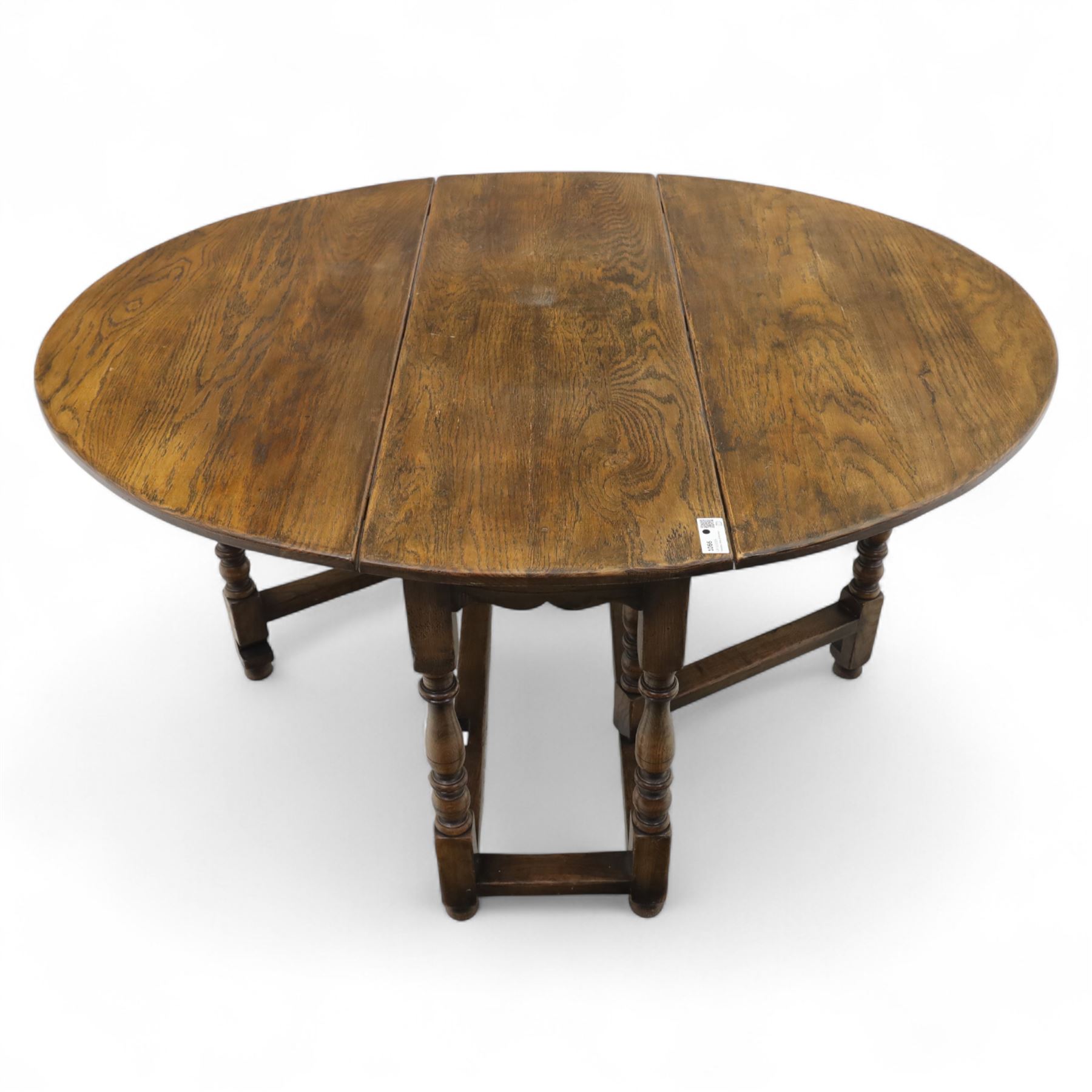 17th century design oak gateleg dining table, oval drop-leaf top on baluster turned supports, twin swinging gate legs united by peripheral stretchers (Extends to 149cm)
