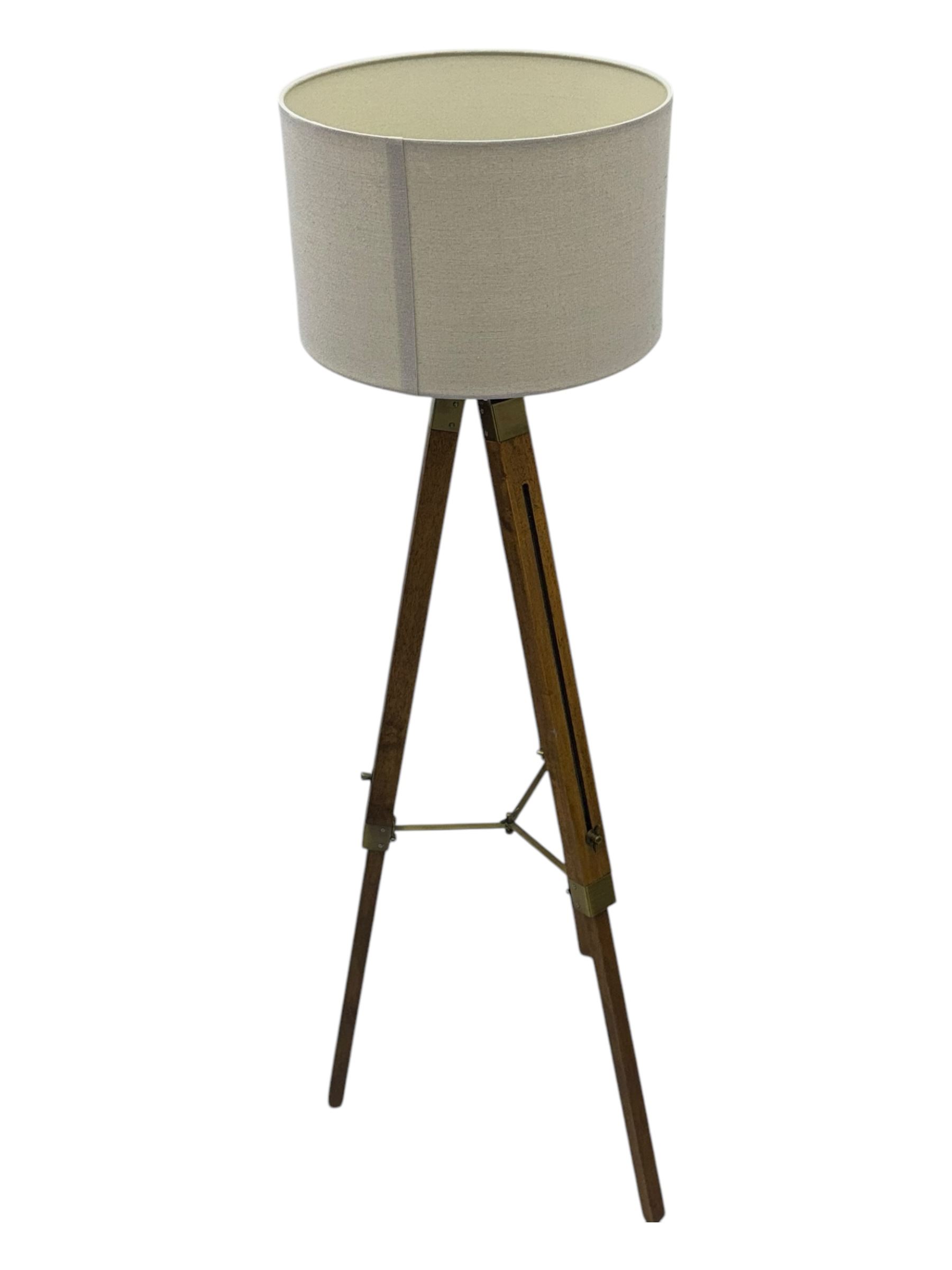 Wooden framed tripod standard lamp, with shade on adjustable legs with brass fititngs