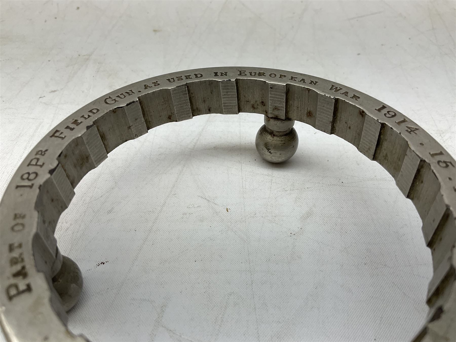 WW1 Trench Art - trivet on three ball feet formed from a section of a gun barrel inscribed 'Part of 18Pr Field Gun, as used in European War 1914.15.16.17.18.' D10cm