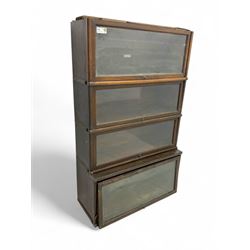 Globe Wernicke - early 20th century oak four-tier stacking library bookcase, four glazed sections enclosed by hinged and sliding doors