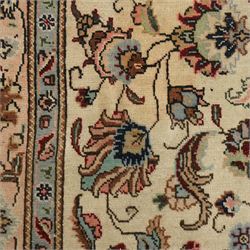 Persian Kashan rug, ivory ground field decorated with an all-over design of scrolling vines and stylized palmettes in pastel tones and conforming floral borders