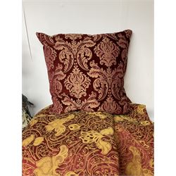 Quilted red and gold bedspread by Sandersons, together with a figural falcon table lamp, red brocade cushion and two red beaded lampshades, bedspread 270cm x 220cm
