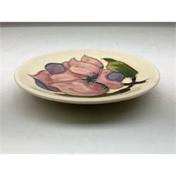 Moorcroft pin dish decorated in the Pink Magnolia pattern on a cream ground, D12cm