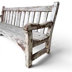 Teak garden bench with slatted back and seat on square supports in weathered which finish 