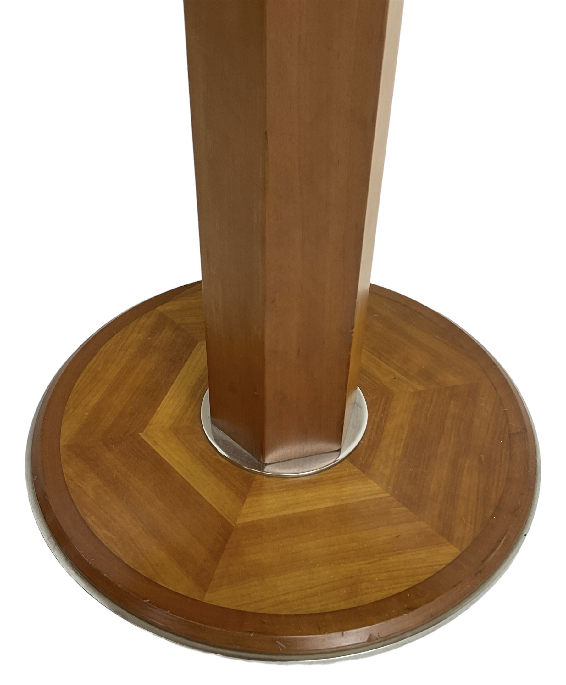 Art Deco design maple and cherry wood pedestal table, circular top with figured quarter matched veneers, mounted by chromed metal band, octagonal pedestal on circular platform base