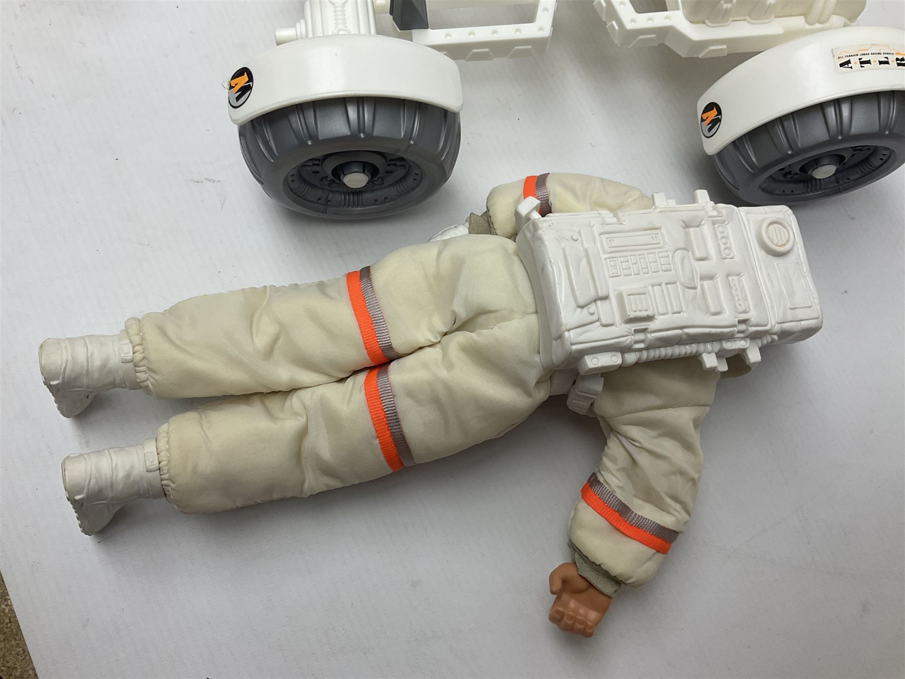 Action Man - large collection of 1960s and later figures and accessories including Spaceman with ATLRV vehicle; two figures marked 'Made in England by Palitoy under licence from Hasbro 1964'; twenty-five assorted weapons; radio backpacks; kit bags; twenty-one pairs of boots; football boots and snow shoes; metal diver's boots and three pairs of flippers; two pairs of jackboots; roller skates; various tunics, trousers, flying suits, jumpers, belts etc; twenty helmets, berets, busby, kepis, submariner etc; and quantity of other accessories