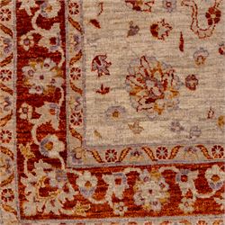 Indian Agra hand knotted rug, the pale beige field decorated with scattered floral sprays and stylised palmettes, enclosed within a wide terracotta border of scrolling foliage and flowerheads between narrow guard bands, finished with fringe ends