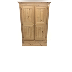  Solid pine wardrobe, projecting cornice, two doors enclosing hanging rail above two drawers, plinth base, W129cm, H195cm, D61cm  