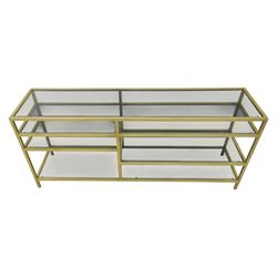 Modern glass and gilt metal media stand, rectangular smoked glass top panel set within a gilt finished metal surround, raised on square section legs, the underside fitted with a full-width glass shelf