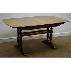  Ercol medium elm extending dining table, four baluster supports joined by stretchers on sledge feet, W92cm, H74cm, D203cm  