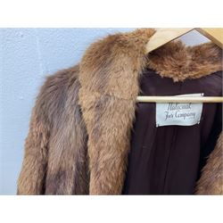 Brown mid length musquash fur coat by National Fur Company together with white rabbit cape