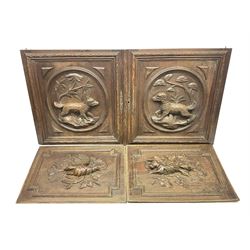 Pair of oak furniture door panels, carved in relief with a fox to one and a hound to the other, together with a pair of smaller oak panels, carved in relief with a hare to one and a grouse to the other, doors W63.cm x H62cm, panels W43cm x H60cm