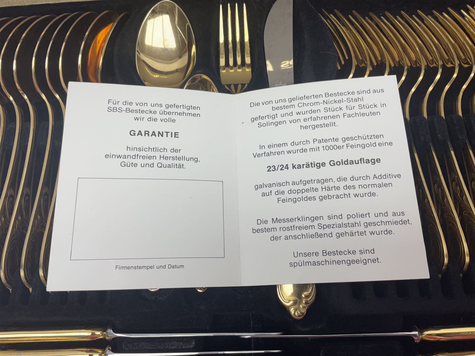 Bestecke Solingen canteen of gold plated cutlery for twelve place settings, including ladle, cake slice and serving spoons, contained within a briefcase, together with a matching set twelve of Bestecke Solingen gold plated fish knives and forks, in fitted case 