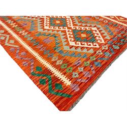Anatolian Turkish Kilim amber ground rug, the field decorated with four lozenges with ivory outline, the double banded orange border with repeating geometric patterns 