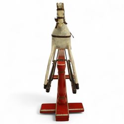 20th century carved and painted rocking horse, with original dappled paint finish, studded leather saddle and reins, on later red and black swing frame