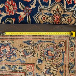 Persian Kashan rug, navy field with lobed central medallion and scrolling floral sprays, ivory spandrels within a palmette and vine border