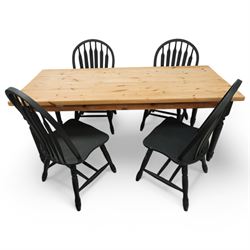 Contemporary country style pine and painted dining table and four chairs, the rectangular plank top with exposed knots and pegged detailing over black painted turned legs, the four Windsor style chairs with shaped seats, spindle splats and turned stretchers, also painted black