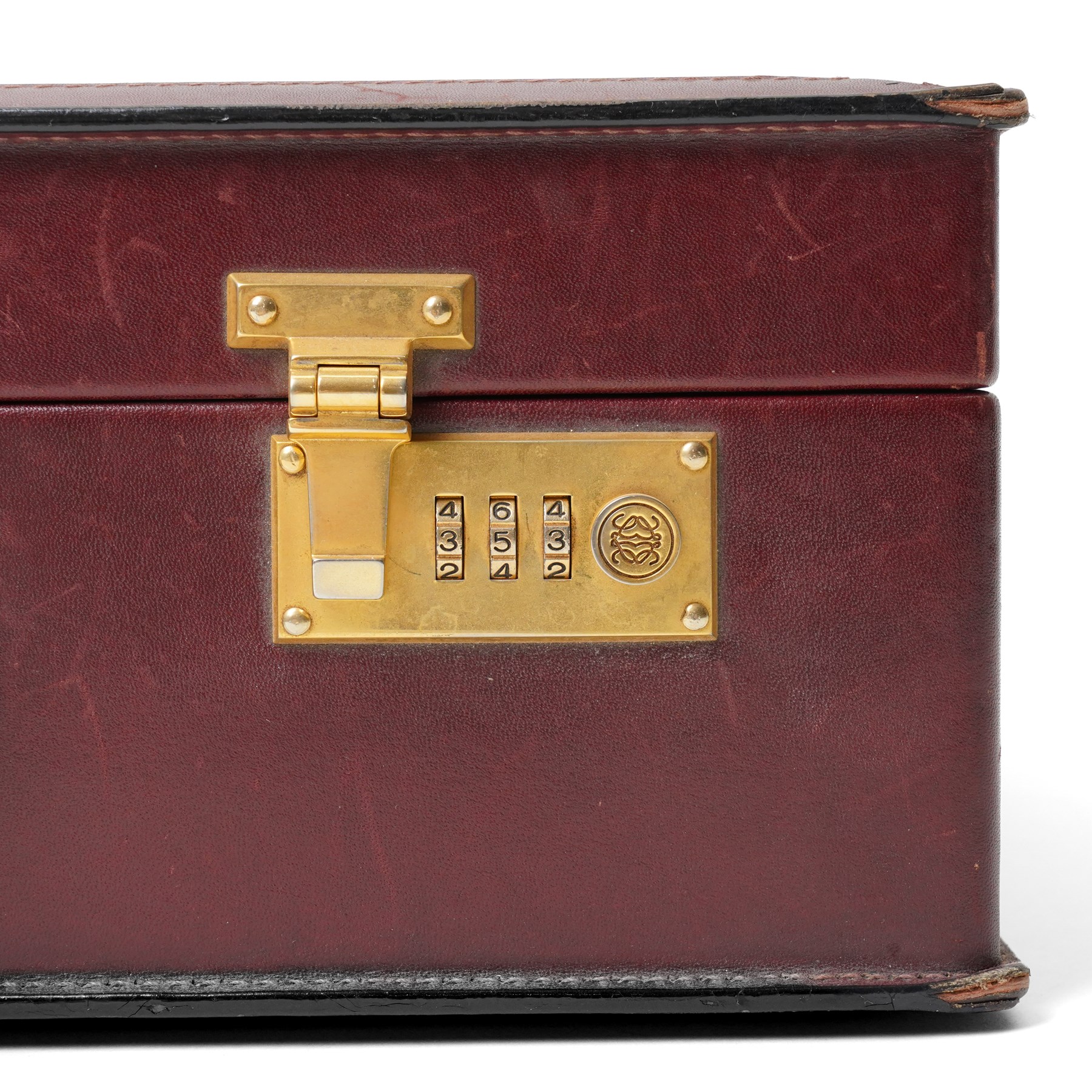Loewe - vintage burgundy leather attaché case, the exterior embossed with Loewe Anagram, with gilt-tone hardware, twin combination locks and leather handle, opening to a suede-lined fitted interior with document compartments, pen loops and pockets, stamped LOEWE Madrid 1846