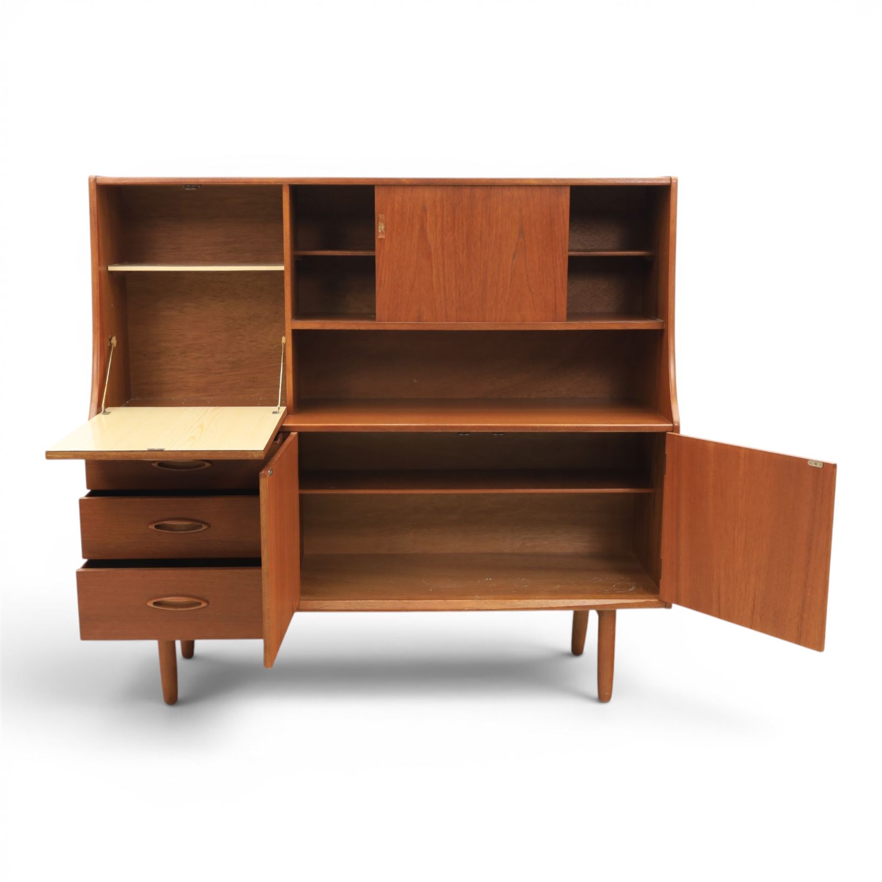 Jentique - mid-20th century teak highboard, fall front cabinet next to a sliding door cupboard above and open recess, the lower section with cabinet doors and three graduated drawers, raised on cylindrical legs
