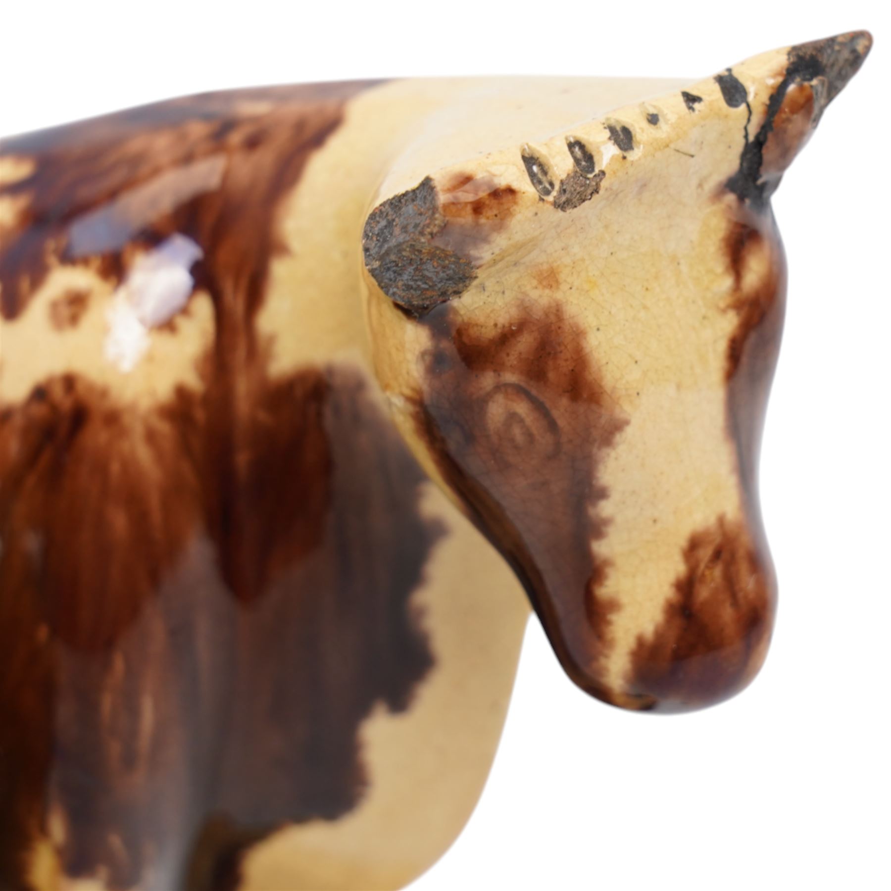 Early 19th century pottery model of a cow with drab colouring accompanied by a standing figure and a dog on naturalistic base, possibly South Yorkshire L14cm x H14cm