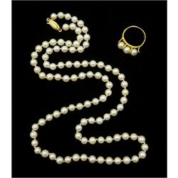 Gold three stone pearl ring and a single strand pearl necklace, with 9ct gold clasp