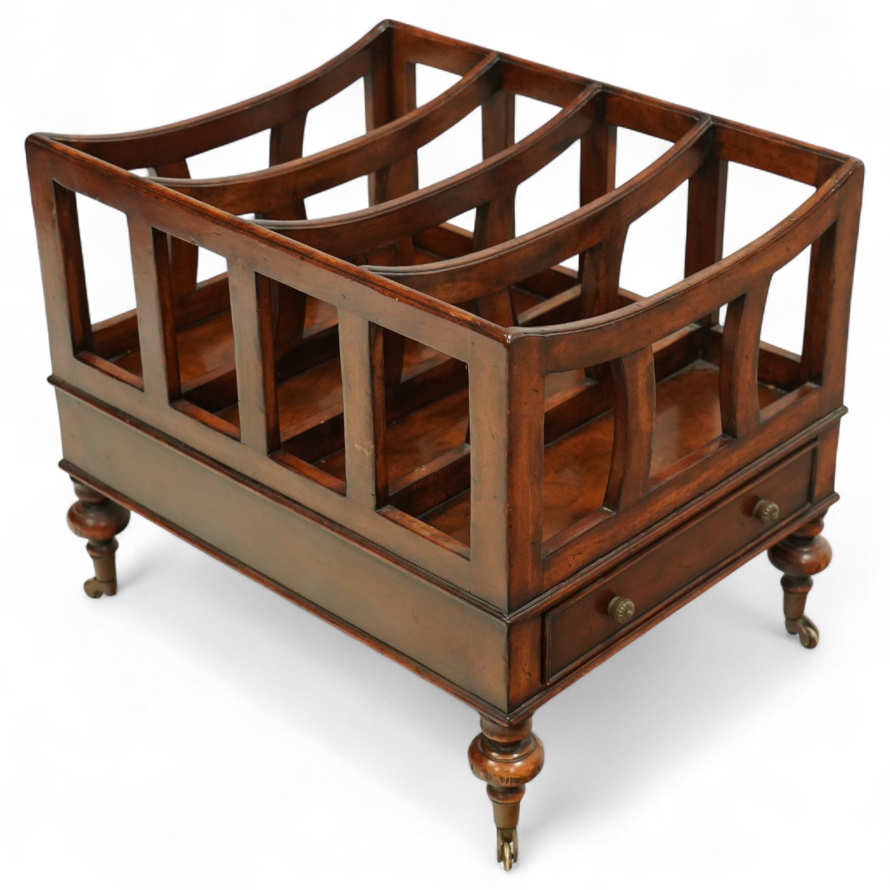 Late 20th century large mahogany canterbury, of rectangular form with four divided curved upper racks, single frieze drawer with brass knob handles, raised on turned legs with brass castors