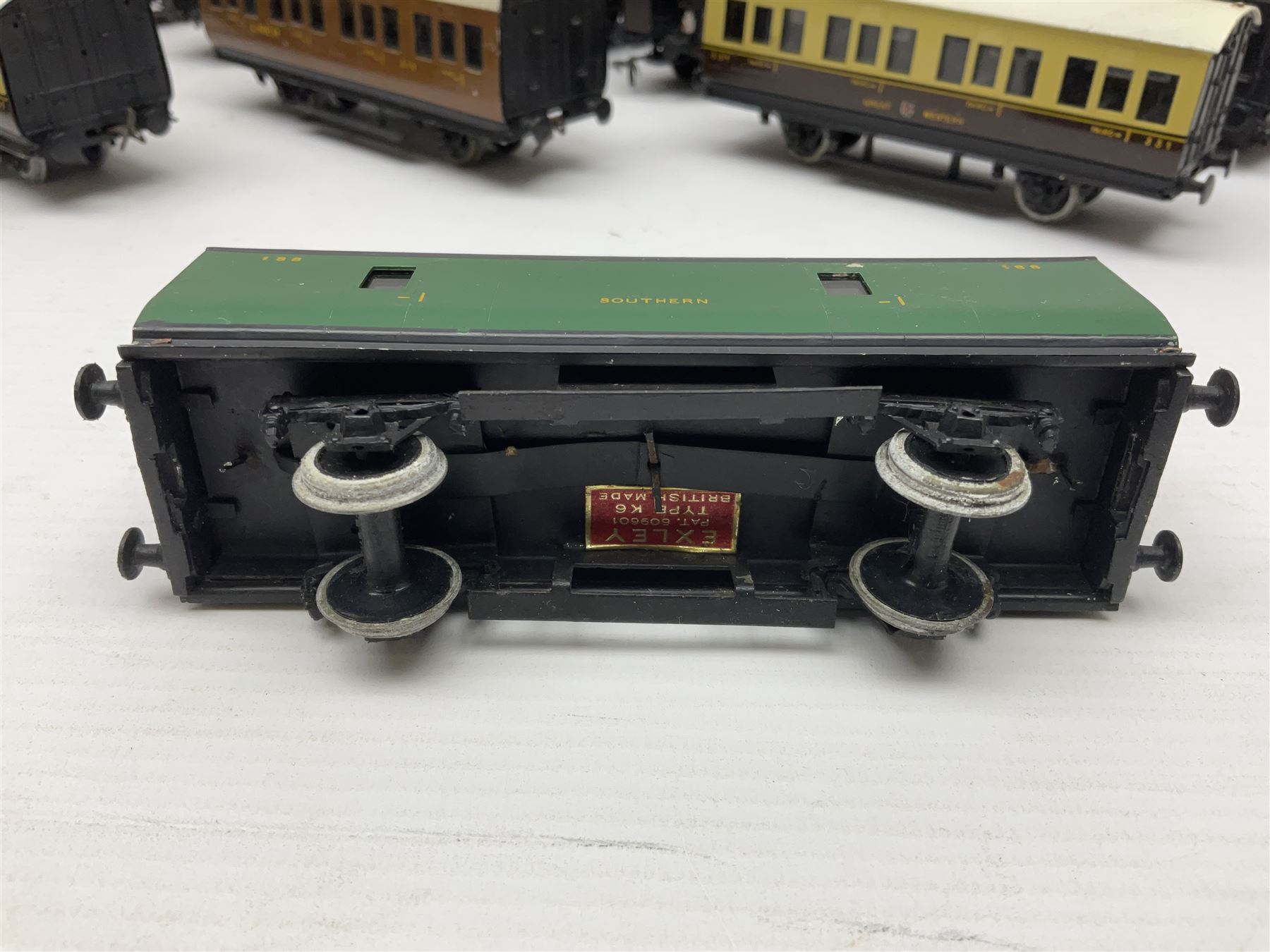 Exley '00' gauge - fourteen various coaches comprising four LMS maroon (3322 3rd, 2202 3rd, 6665 3rd and 388 Sleeping Car 3rd), LNER green/cream Buffet Car 21419, LNER teak 8639 1st, Southern green 6688 3rd, GWR brown/cream 3322 3rd, LNER 206 3rd, LNER 319 1st/3rd, SR green 351 3rd, SR green 188 Parcel Van, GWR 331 3rd and GWR 362 3rd; all unboxed (14)