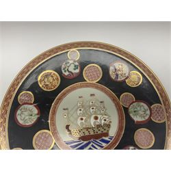 Chinese export charger, the centre decorated in enamel with a ship at full sail, surrounded by enamel panels of bamboo and cherry blossom with gilt edging on a black ground, with red and gilt border, with painted character marks beneath D34.4cm