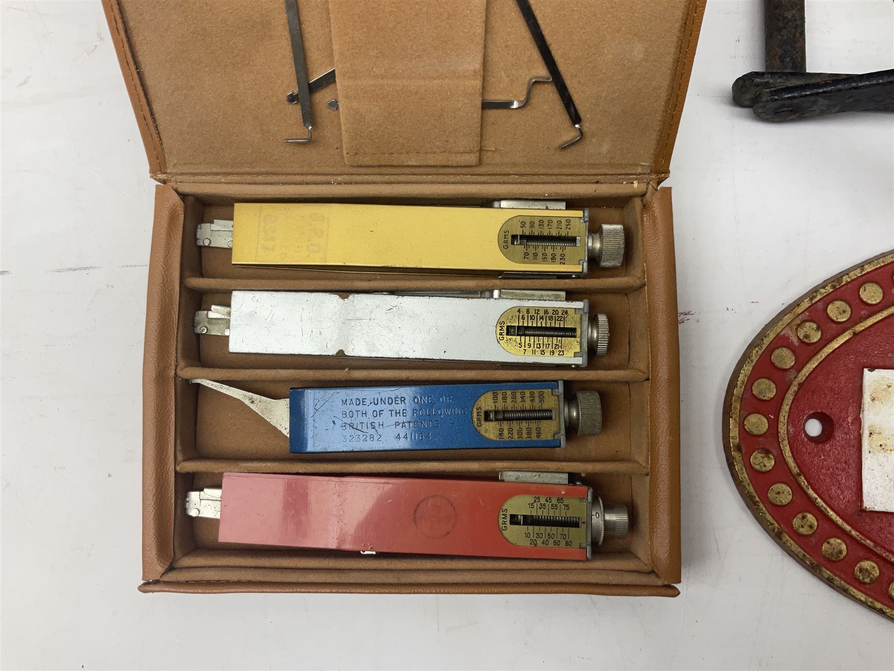 Bugatti cast iron sign with a red background, Shell Oil cast iron sign with gold background, together with Land Rover oil can, motorist warning lamp & torch tool kit and other motoring items 