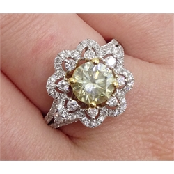  18ct white gold diamond flower cluster ring, the central fancy brilliant cut diamond of approx 1.35 carat, with diamond set surround and shoulders, stamped 750  