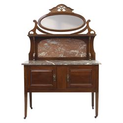 20th century mahogany marble topped washstand, rectangular veined grey marble top over two panelled cupboard doors with ring handles, raised on square tapering supports terminating in castors, the rear fitted with shaped back and oval swing mirror within a scroll cut frame surmounted by pierced cresting