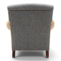Tetrad - 'Taransay' Harris Tweed and tan leather club armchair, Howard shape with reclined back over deep seat and rolled arms with studwork, raised on turned front supports with castors, the sides and arms upholstered in tan leather with seat and back in herringbone-stitched Harris Tweed