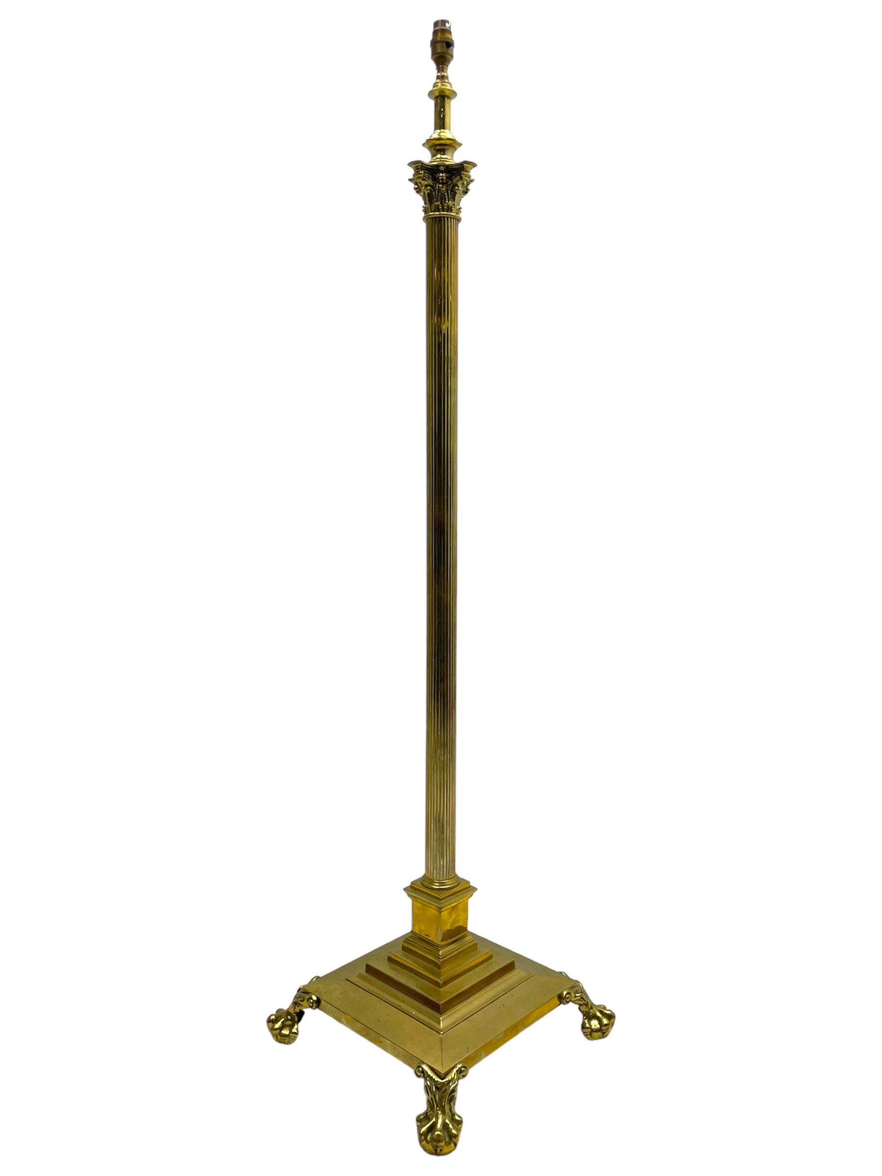 Late 20th century brass telescopic standard lamp in the form of a Corinthian column, Corinthian acanthus leaf capital over reeded shaft, stepped and moulded square base with four extending ball and claw feet
