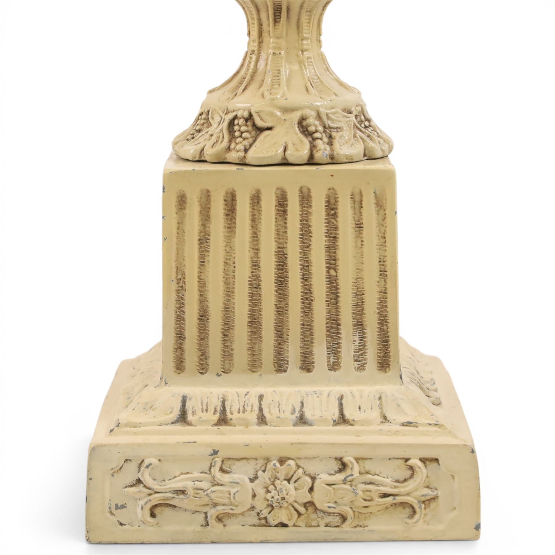 Table lamp modelled as a twin handled urn, decorated in relief with floral sprigs, upon a stepped rectangular base, with a cram lampshade, H53cm, without lampshade 