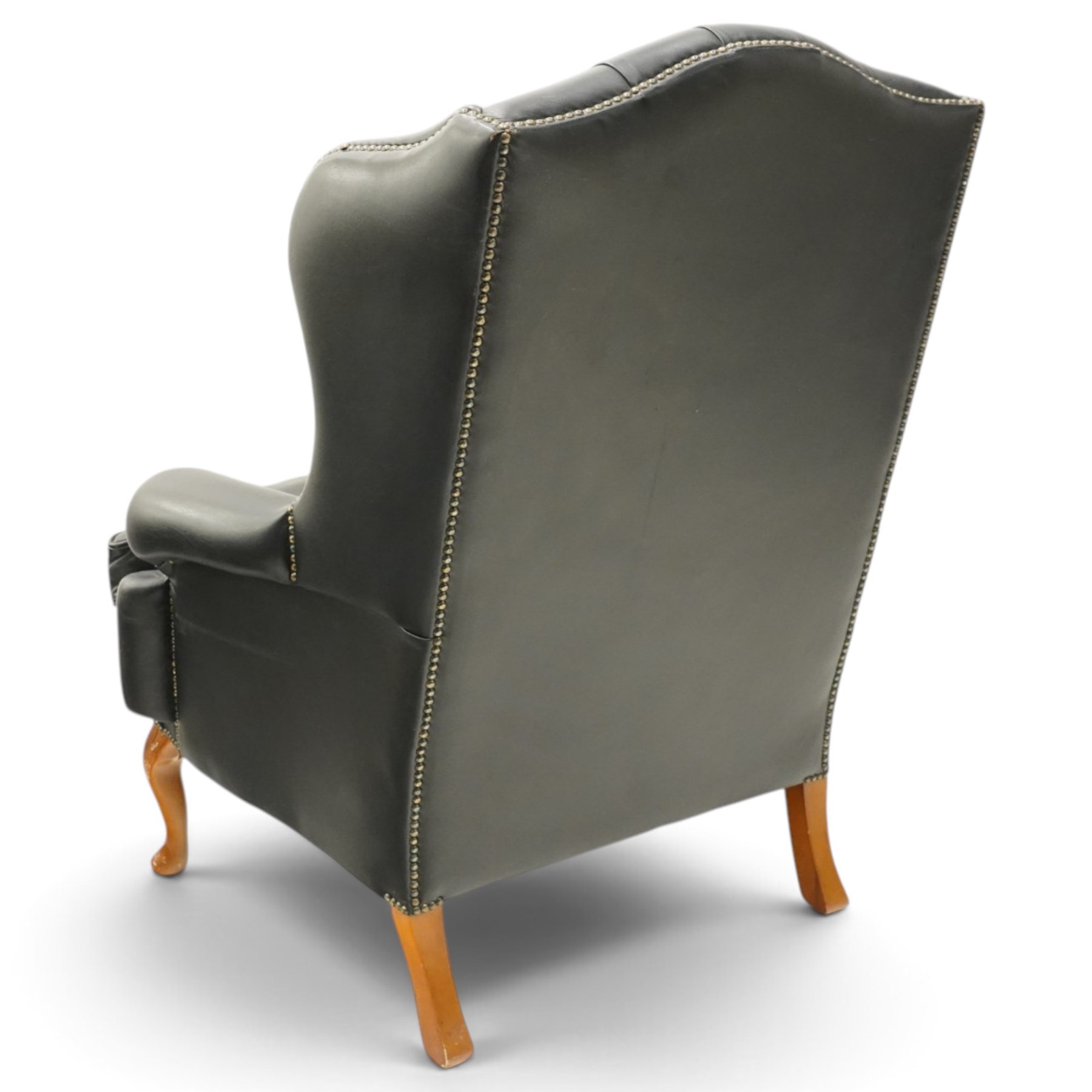 Pair of quality Georgian design wingback club armchairs, the high arched back with wings over rolled arms, upholstered in back-buttoned black leather with loose seat cushion, raised on foliate carved cabriole supports