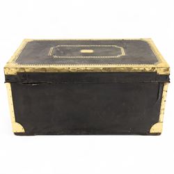 An early 19th-century Georgian brass-bound travelling trunk, leather-covered exterior with brass stud work decoration, front with central brass lock plate, hinged lid with camphor wood interior, external sides fitted with large brass carrying handles 