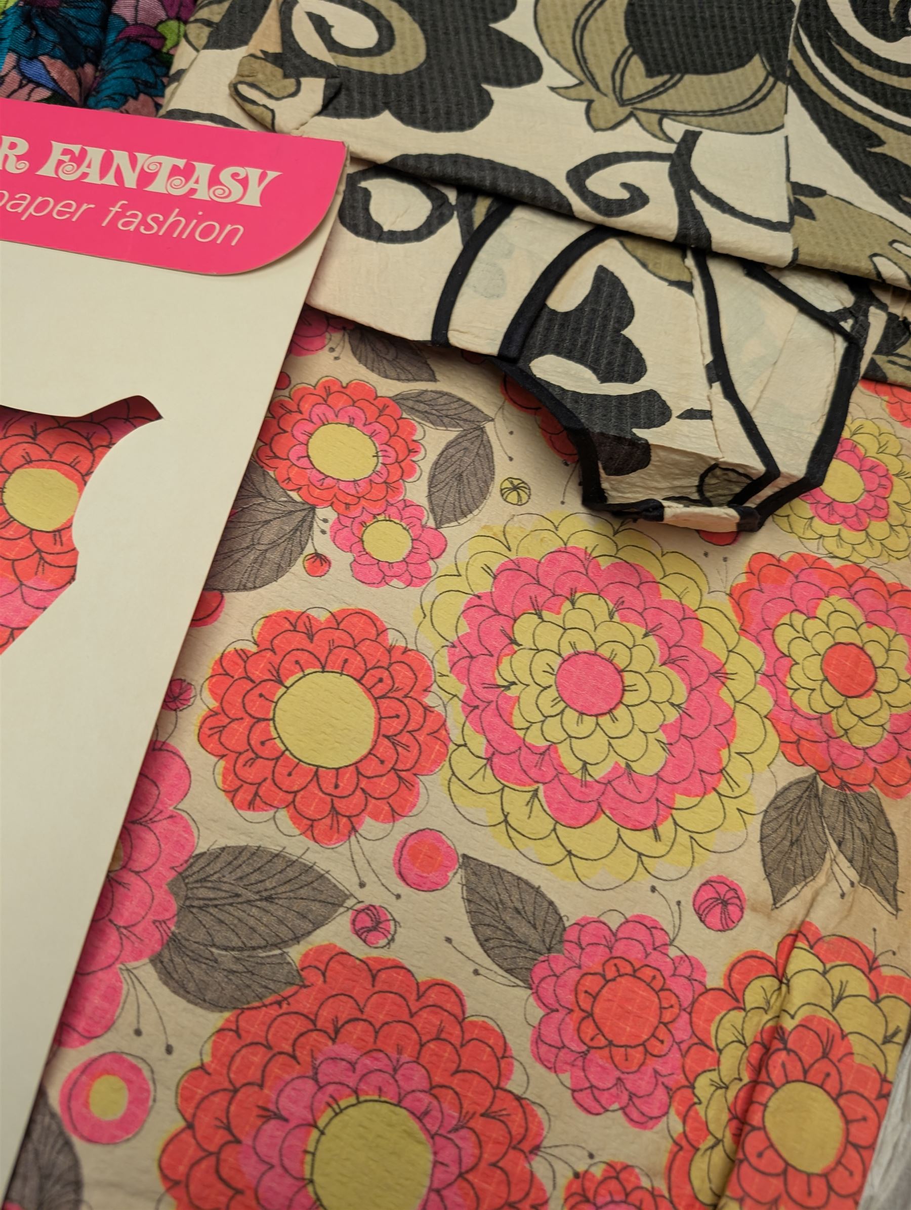 Two 1960s paper dresses and a bright patterned velvet skirt