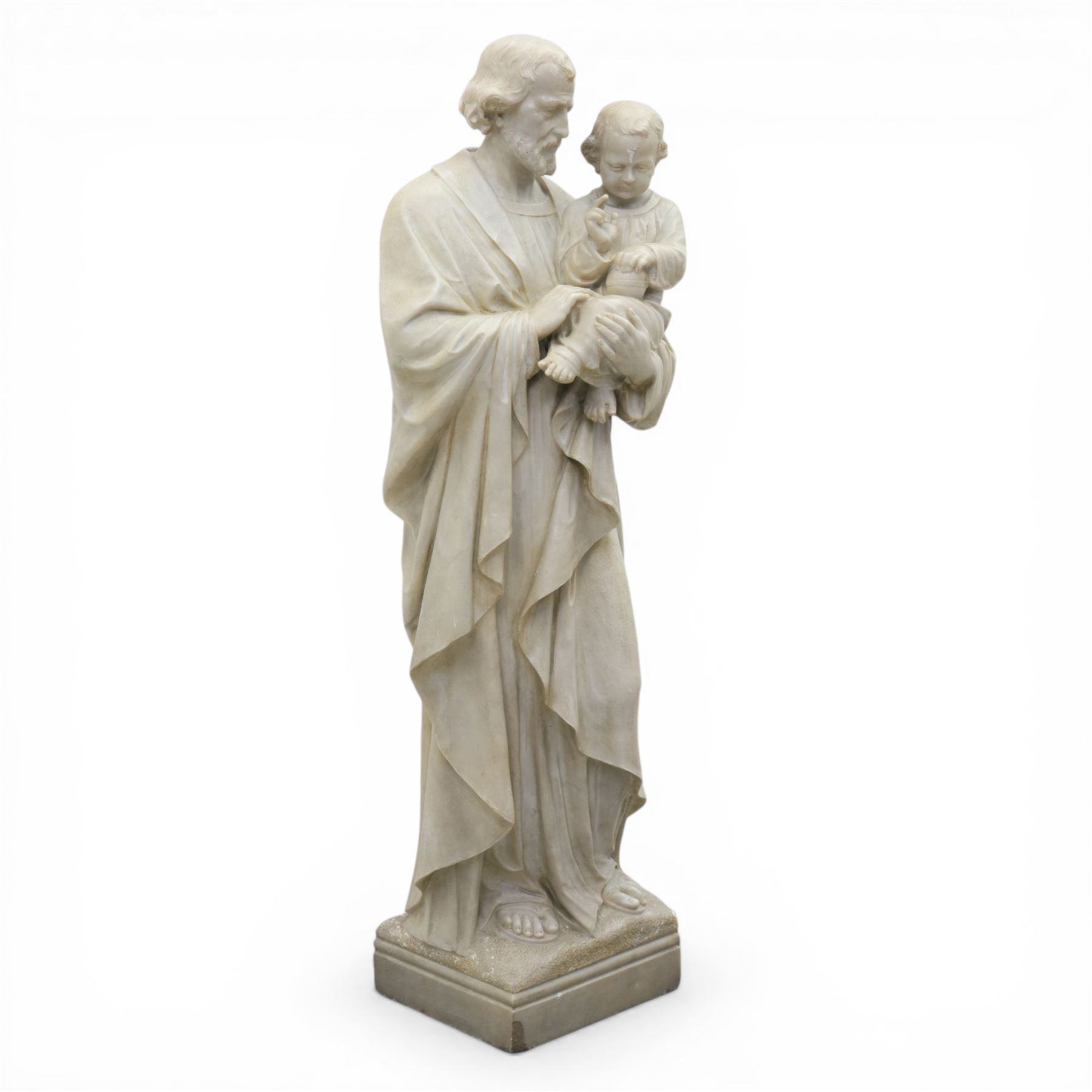 Carved stone and alabaster figure group of Saint Joseph and the Christ Child, modelled standing holding the infant, draped in flowing robes, raised on square plinth base