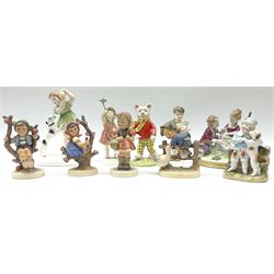 Royal Worcester 'Three's Company' figure, Royal Worcester 'Let's run', Royal Doulton Rupert Bear, Crown Staffordshire figure of girl with a dog, a Victorian fairing, continental figure of a boy and girl and four Hummel figures.   