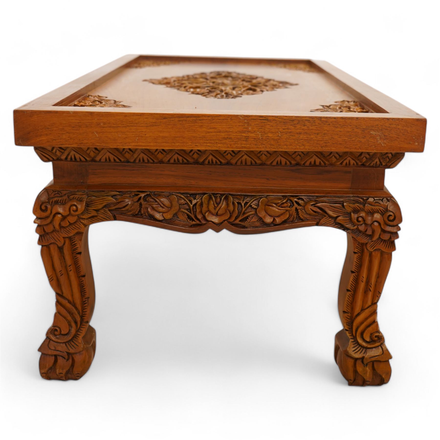 Hardwood rectangular coffee table, carved with trailing branches with foliage and flower heads, on scroll carved cabriole feet 
