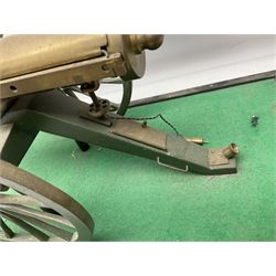 Scratch built brass model of an 1861 Gatling Gun with rotating barrels, hinged cover revealing mechanism, on metal bound wooden spoked wheels and rectangular base L47cm H22cm