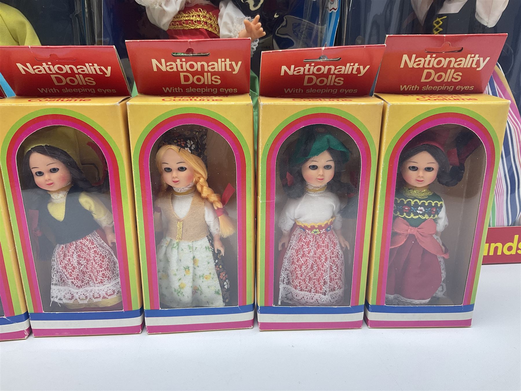 Four Mayfair Products Musical Dolls of Many Lands; original boxes and delivery boxes; and set of twelve Nationality Dolls with Sleeping Eyes; boxed (16)