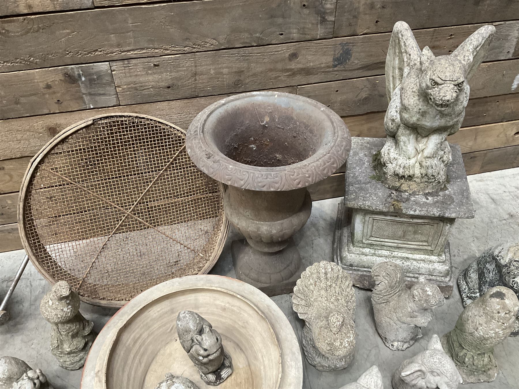 Small Victorian style cast iron urn, cast stone griffin on plinth, 13 garden figures, old vice and other items. 