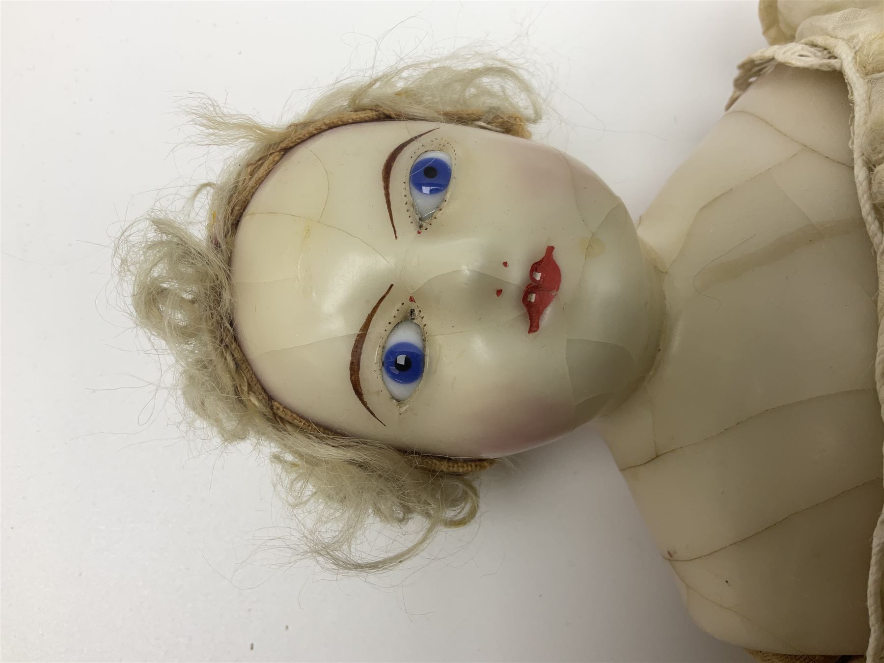 Victorian wax shoulder head doll with pale complexion, applied hair, inset glass eyes and fabric covered jointed body with kid leather lower arms; white linen dress and undergarments H50cm