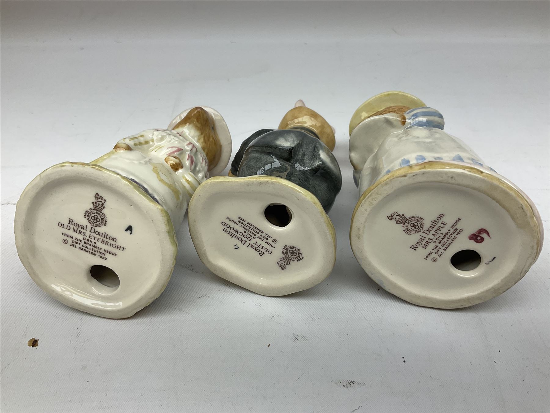 Fifteen Royal Doulton Brambly Hedge figures, comprising Wilfred Toadflax, Dusty Dogwood, Mrs Toadflax, Mr Apple, Primrose Woodmouse, Lord Woodmouse, Poppy Everbright, two Lady Woodmouse, two Old Mrs Everbright, Mr Toadflax, Mrs Apple, Santa Bunnykins and Bunnykins, together with three Royal Albert Wind in the Willows figures comprising Ratty, Badger and Mole, all with printed marks beneath (18)